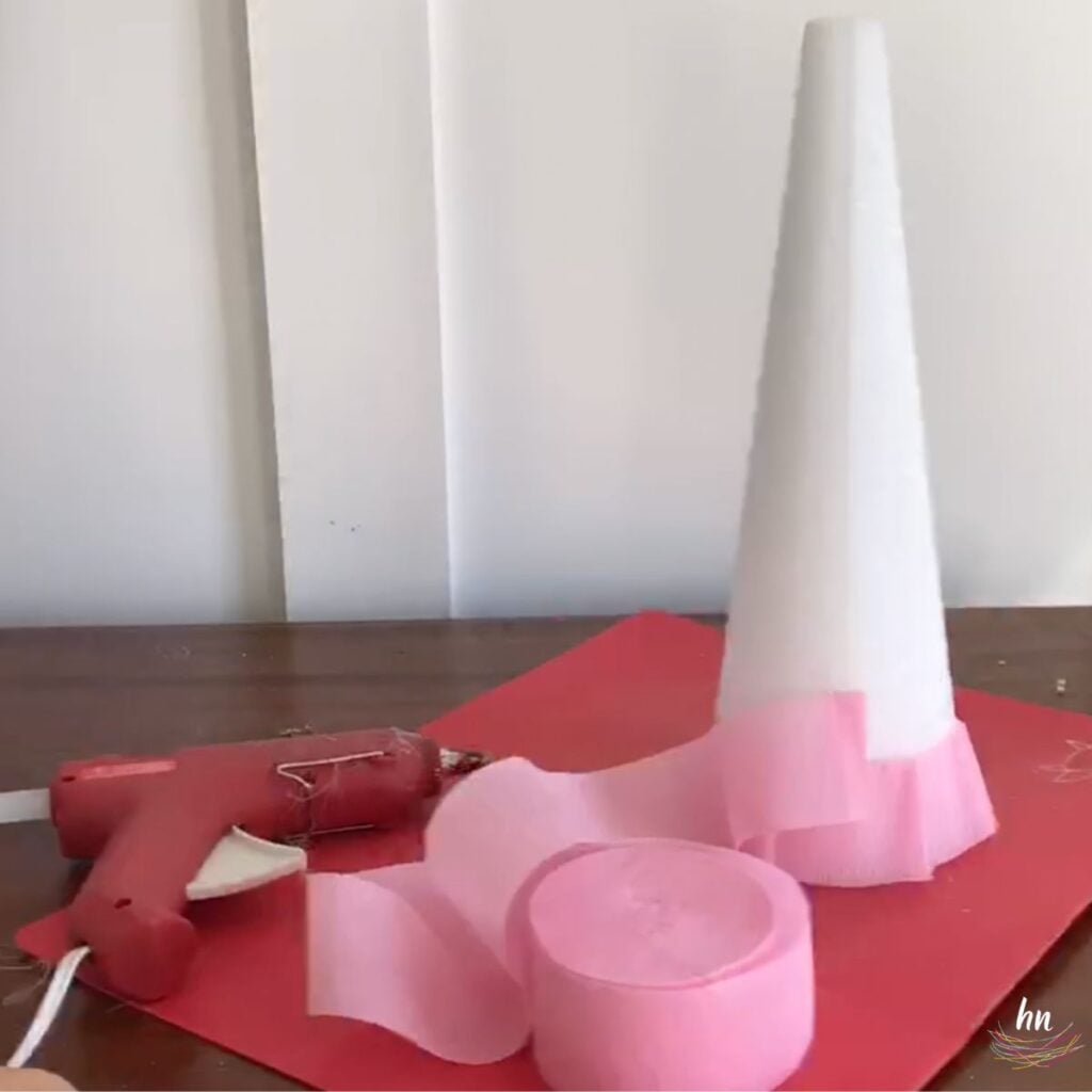 showing step by step process of creating a DIY Christmas tree with a styrofoam cone, hot glue and crepe paper