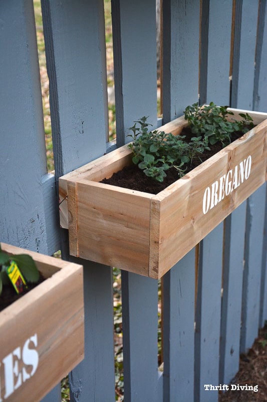 DIY wood planter boxes attached with french cleat to blue/gray fence