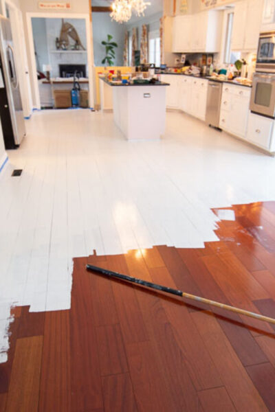 how to paint wood floors | in process of priming floors before paint - we did NOT sand!