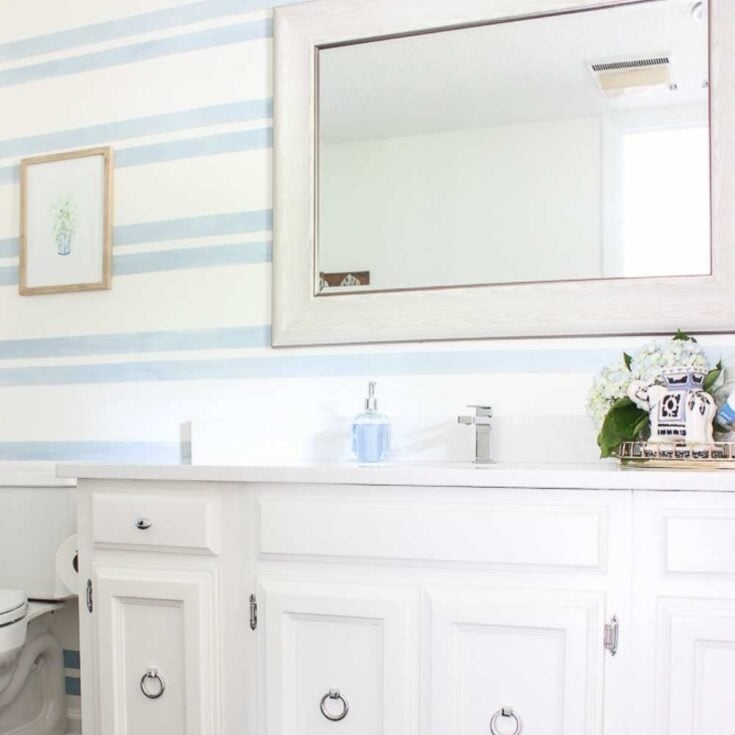 blue striped painted accent wall in bathroom