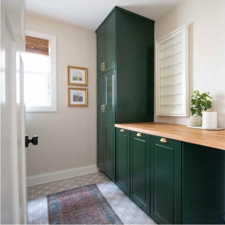 IKEA Karlby countertops in a laundry room renovation with dark green cabinets and tile