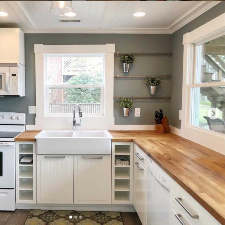 IKEA Karlby counters in a lake cottage kitchen remodel with white cabinetry, gray walls and an apron style farmhouse sink