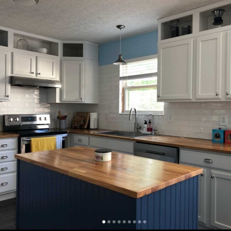 IKEA Karlby butcher block counters in a DIY kitchen remodel with blue island, white cabinetry, white subway tile