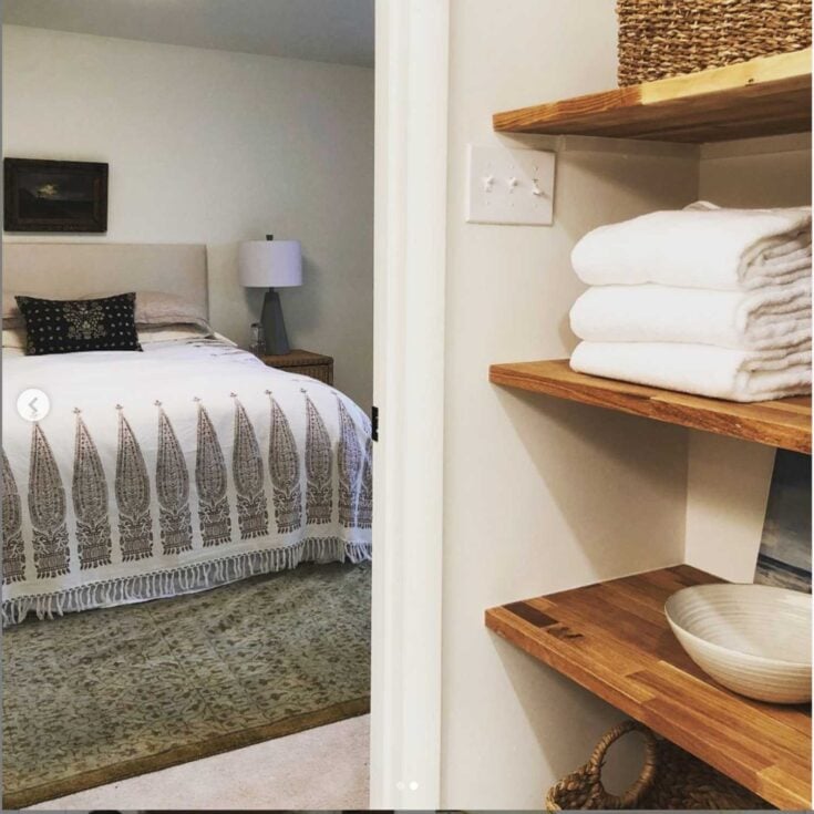 floating shelves in a bedroom linen closet with IKEA Karlby butcher block