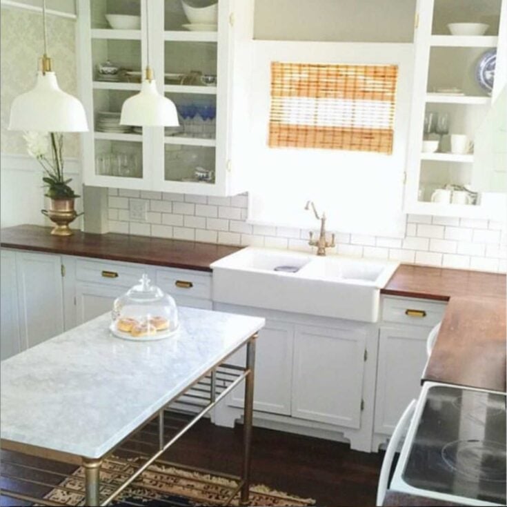 farmhouse style kitchen with apron sink, butcher block countertops with marble island