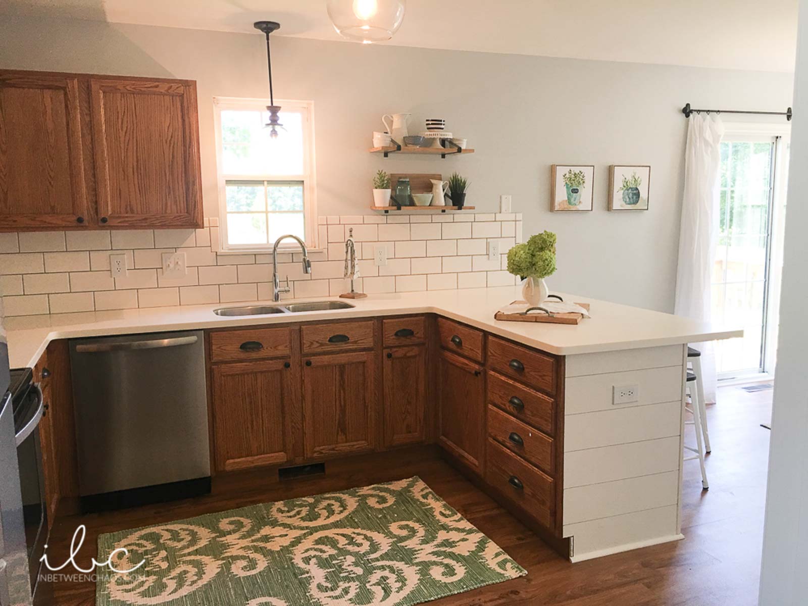 olympus white featured behind white subway tile backsplash in a casual kitchen space