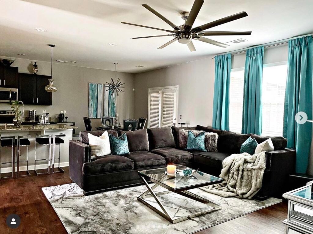 Key Elements Design living room painted in Light French Gray with a ceiling fan and lots of teal accents