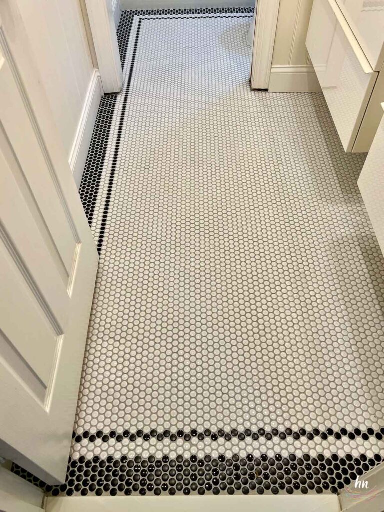 penny tile bathroom floor, white with black border